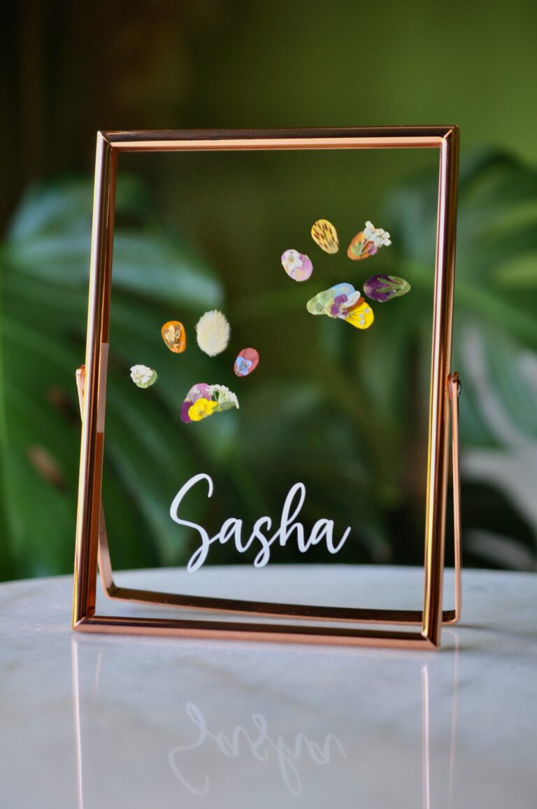 Dog paw print made from real pressed flowers in a rose gold glass frame with the name “Sasha.”