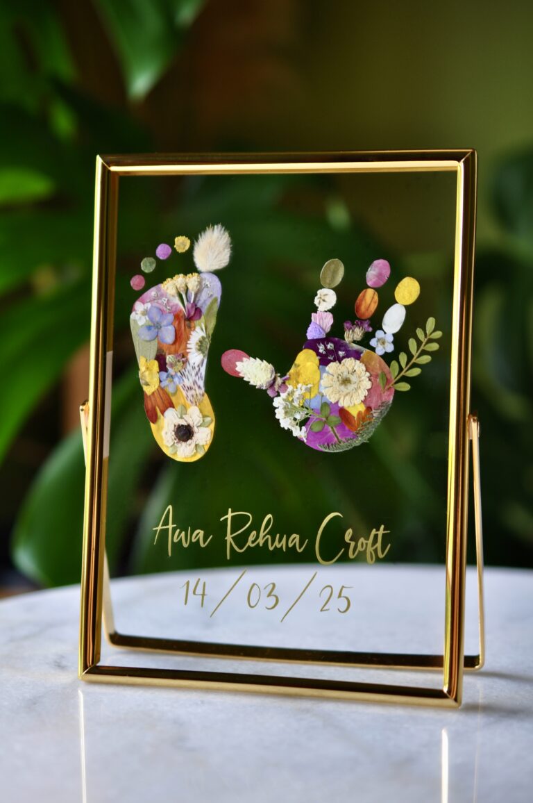 Personalised baby hand and footprint made from real pressed flowers with the name Awa and birth date.