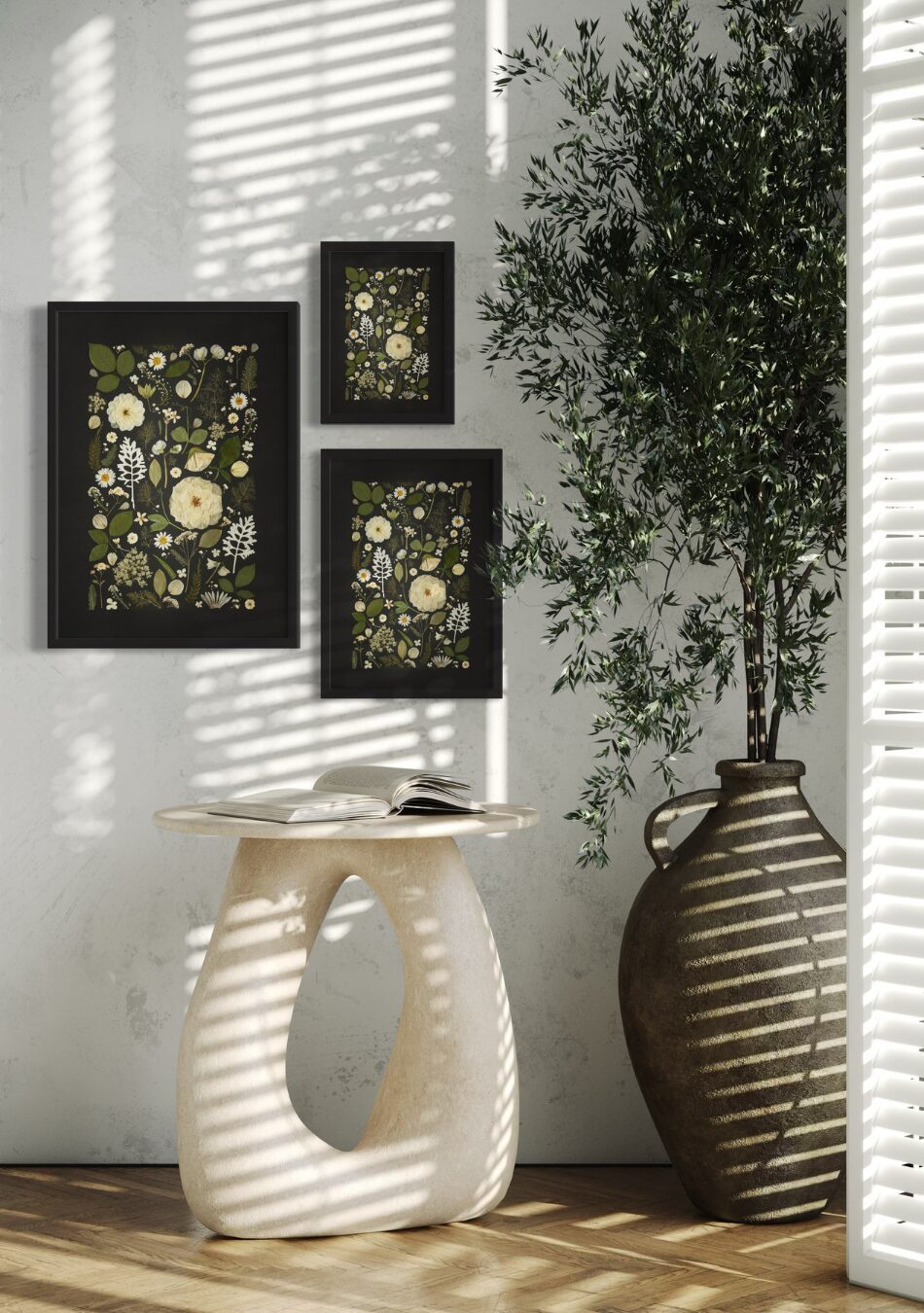 Three framed Midnight Meadow fine art prints made from white pressed flowers and greenery on a deep black background, styled on a neutral wall above a wooden sideboard.