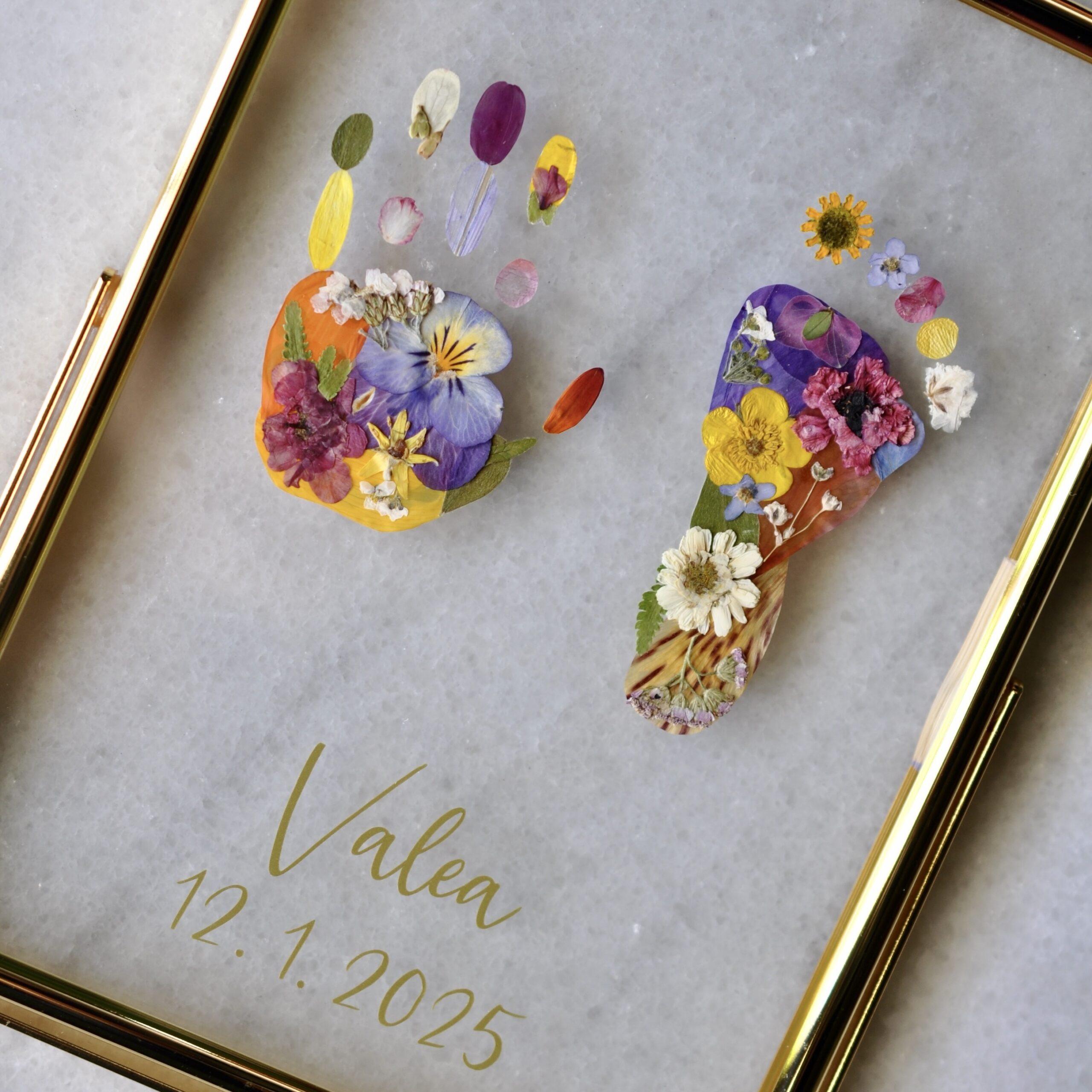 Personalised baby hand and footprint made from real pressed flowers with the name Valea and date of birth.