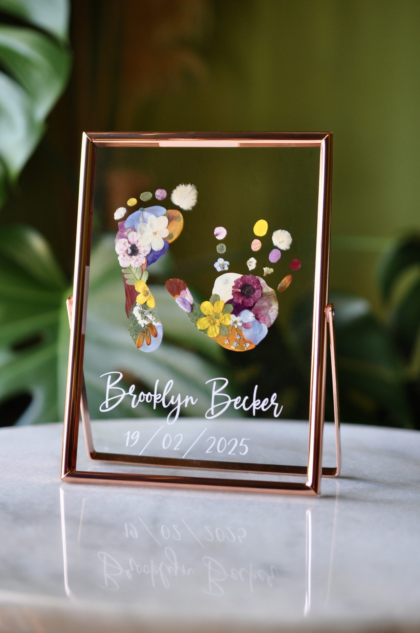 Custom baby hand and footprint keepsake with real pressed flowers in a rose golden frame – personalised newborn gift idea.