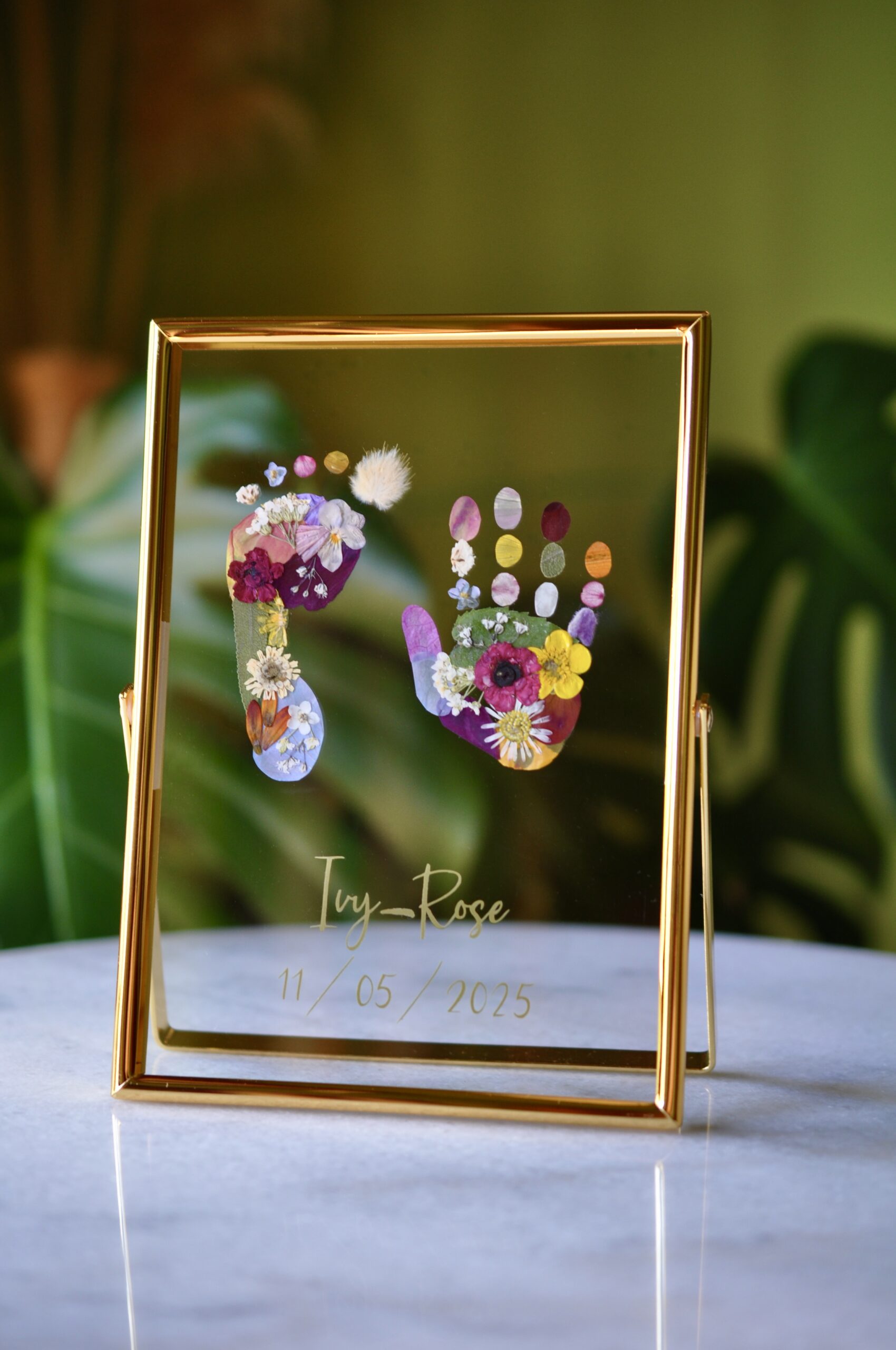 Baby hand and footprint keepsake in an elegant gold frame – custom floral artwork with real pressed flowers, perfect for a newborn gift.