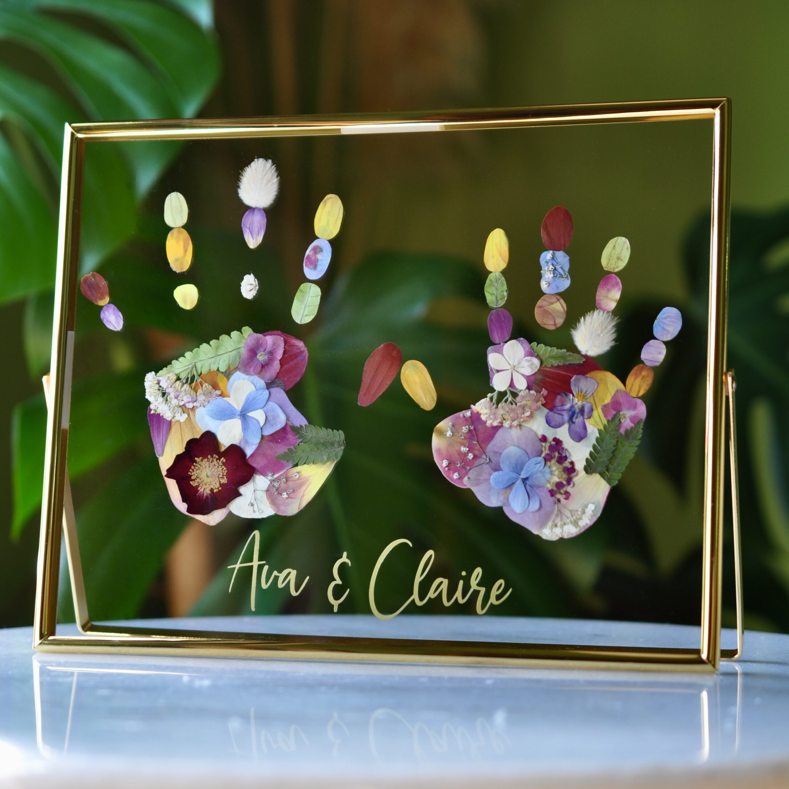 Sibling Handprint Keepsake out of pressed flowers in golden frame