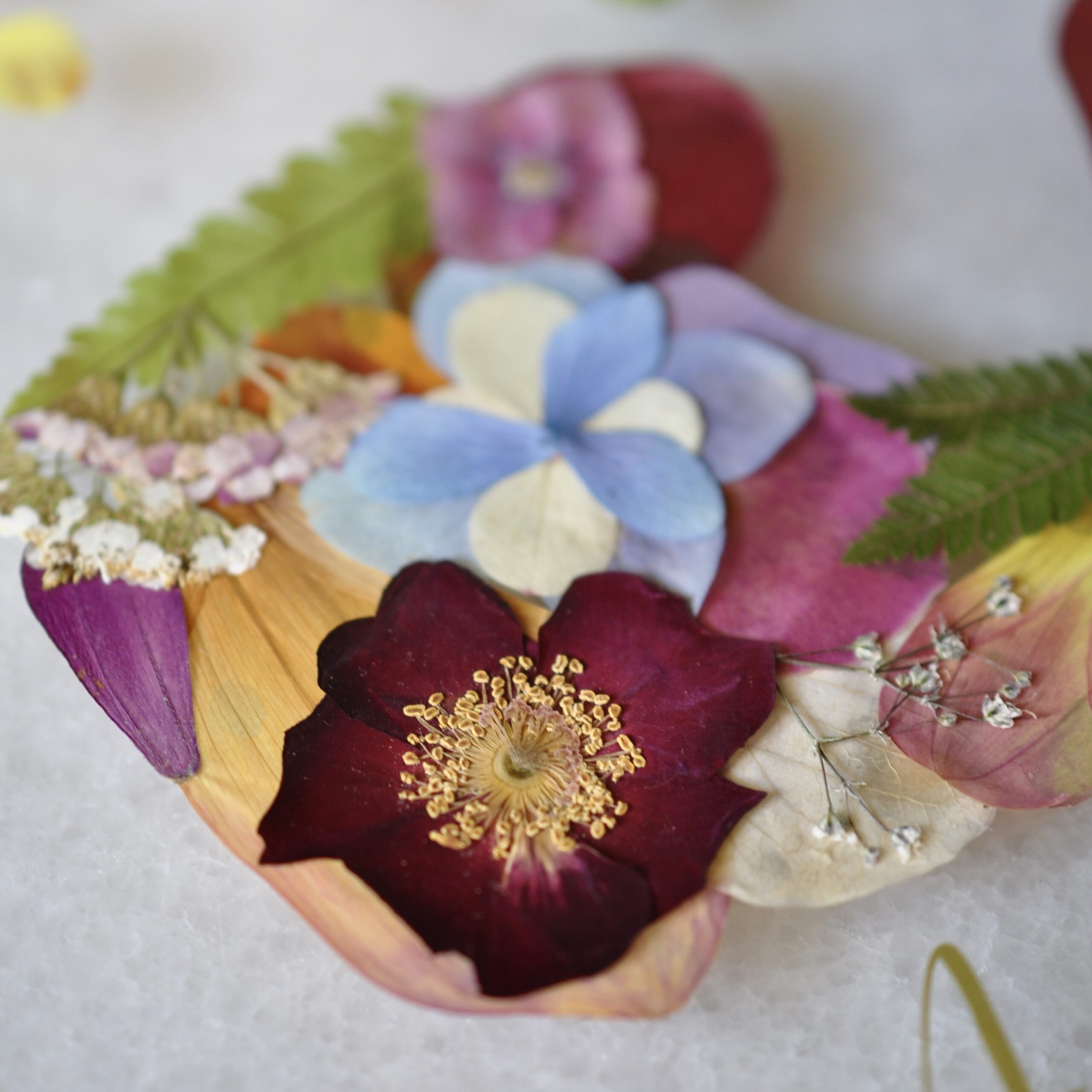 Close-up of baby keepsake out of real pressed flowers.