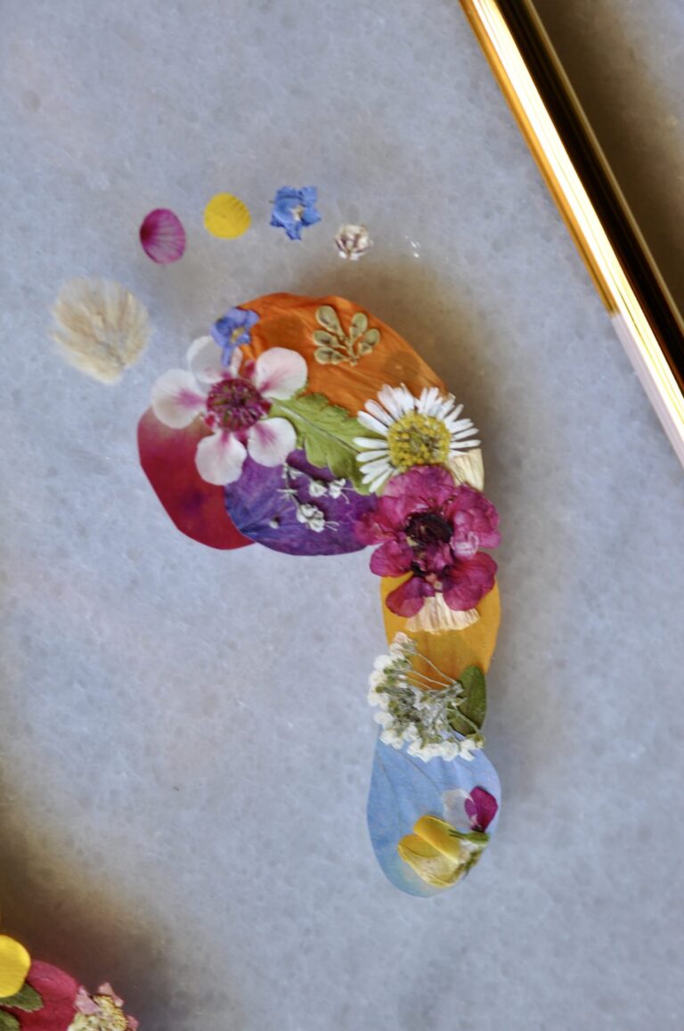 Close up of baby foot made out of real pressed flowers