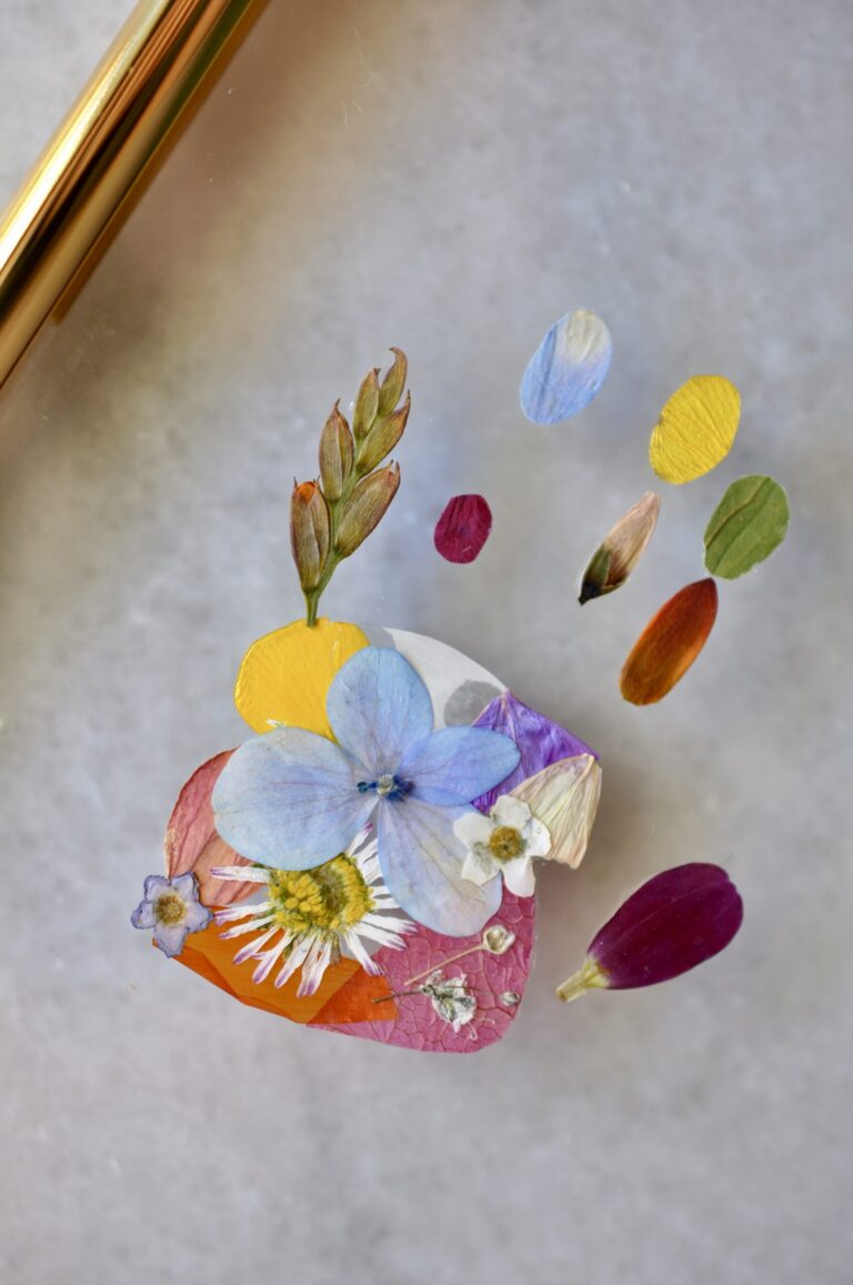 close up of tiny angel baby hand out of pressed flowers