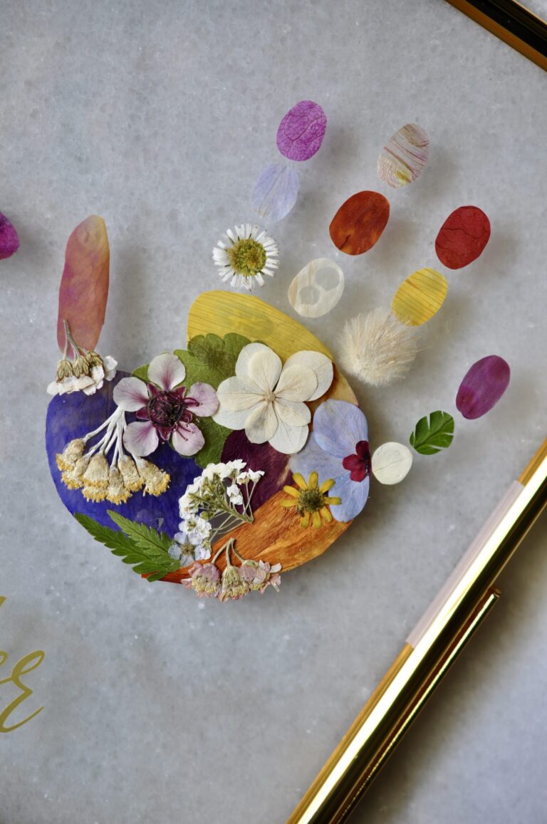 Close-up of baby handprint out of pressed flowers