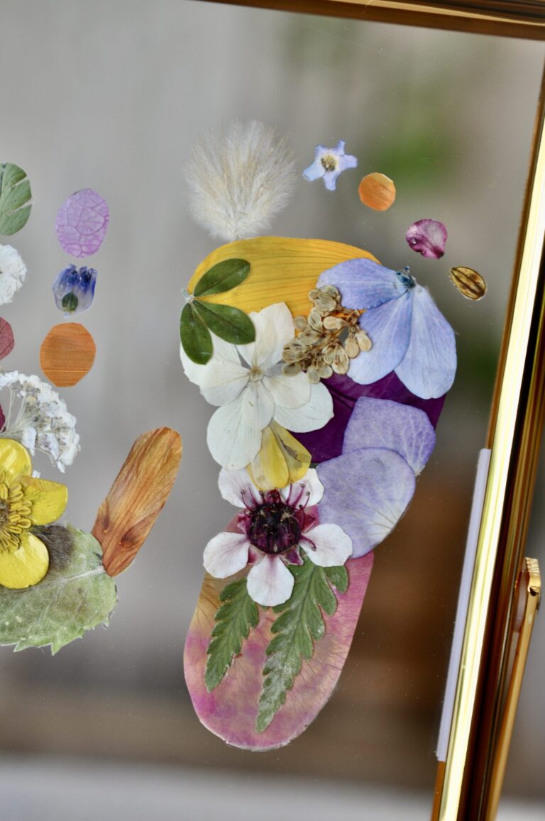 Close-up of baby footprint out of pressed flowers
