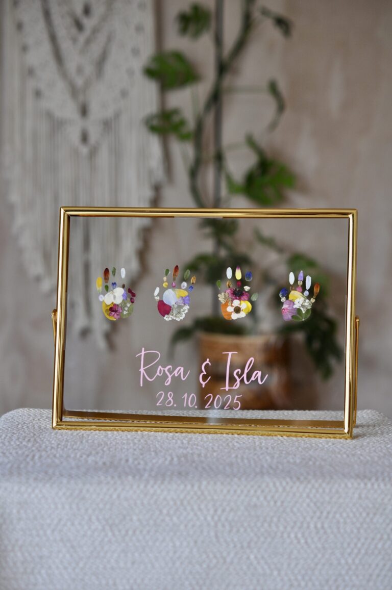 Four tiny handprints out of flowers in golden frame with name and birth date
