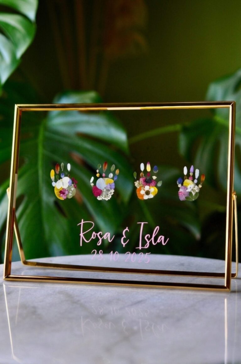 Handprints out of pressed flowers in golden frame with name writing