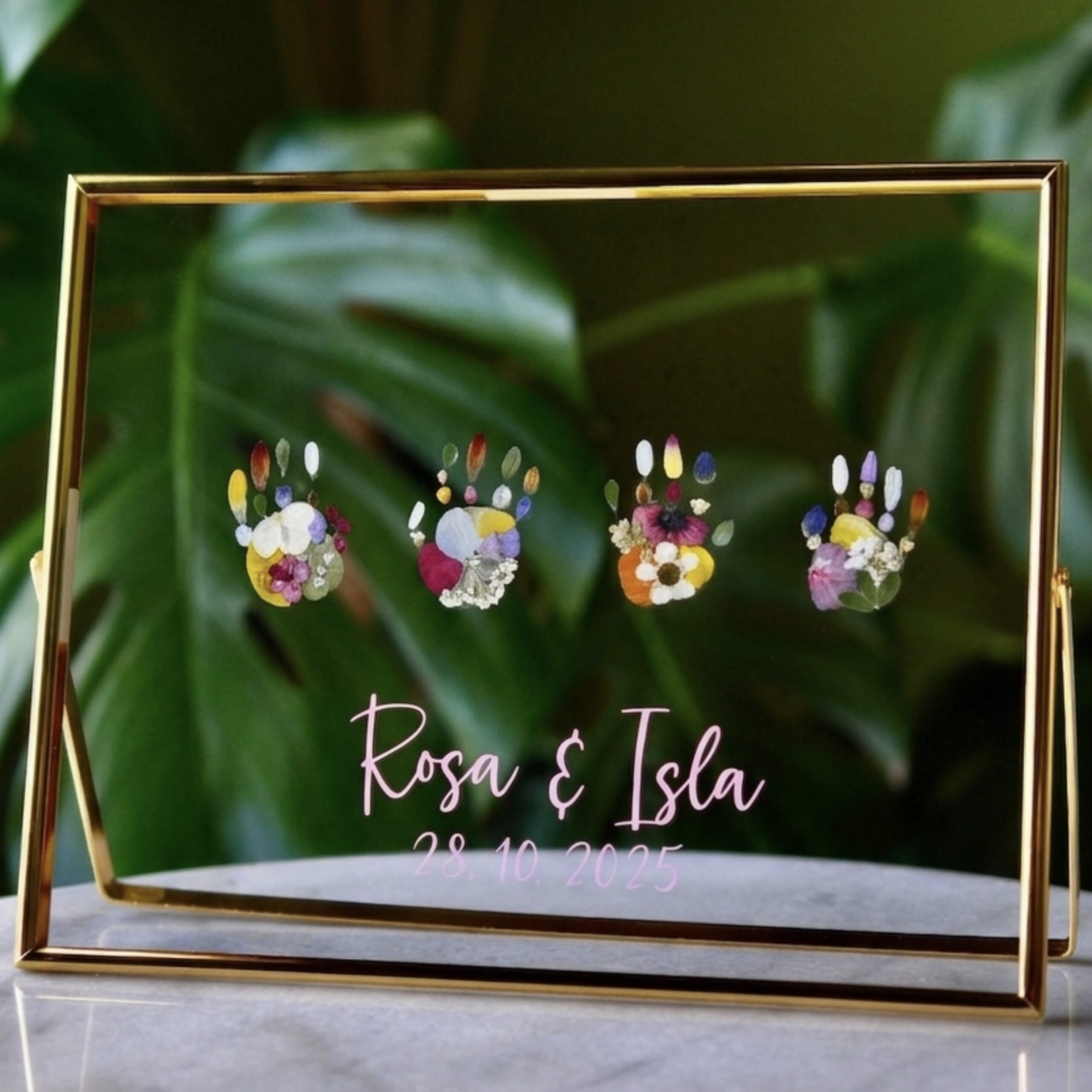 Baby Keepsake features 4 handprint out of pressed flowers with name writing in golden floating frame