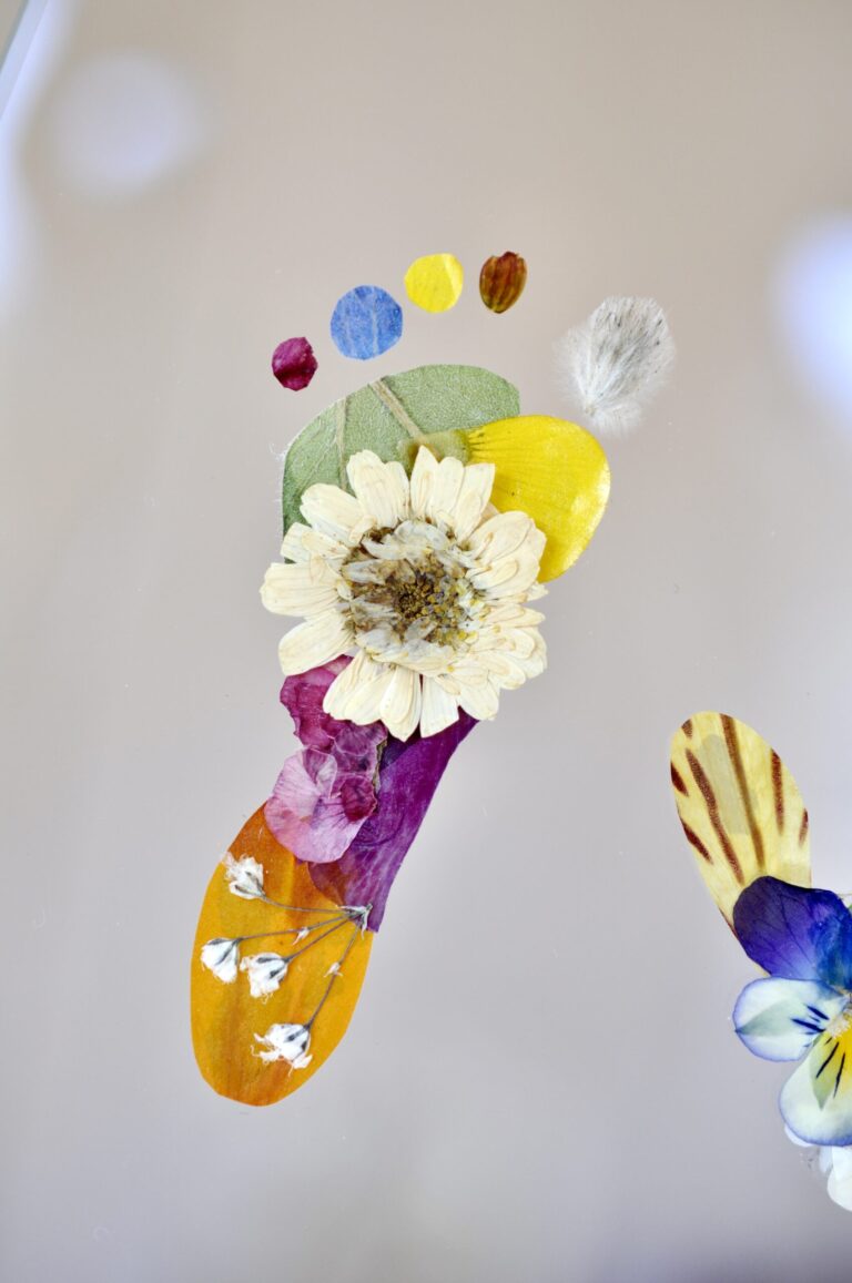 Close up baby footprint made out of pressed flowers.