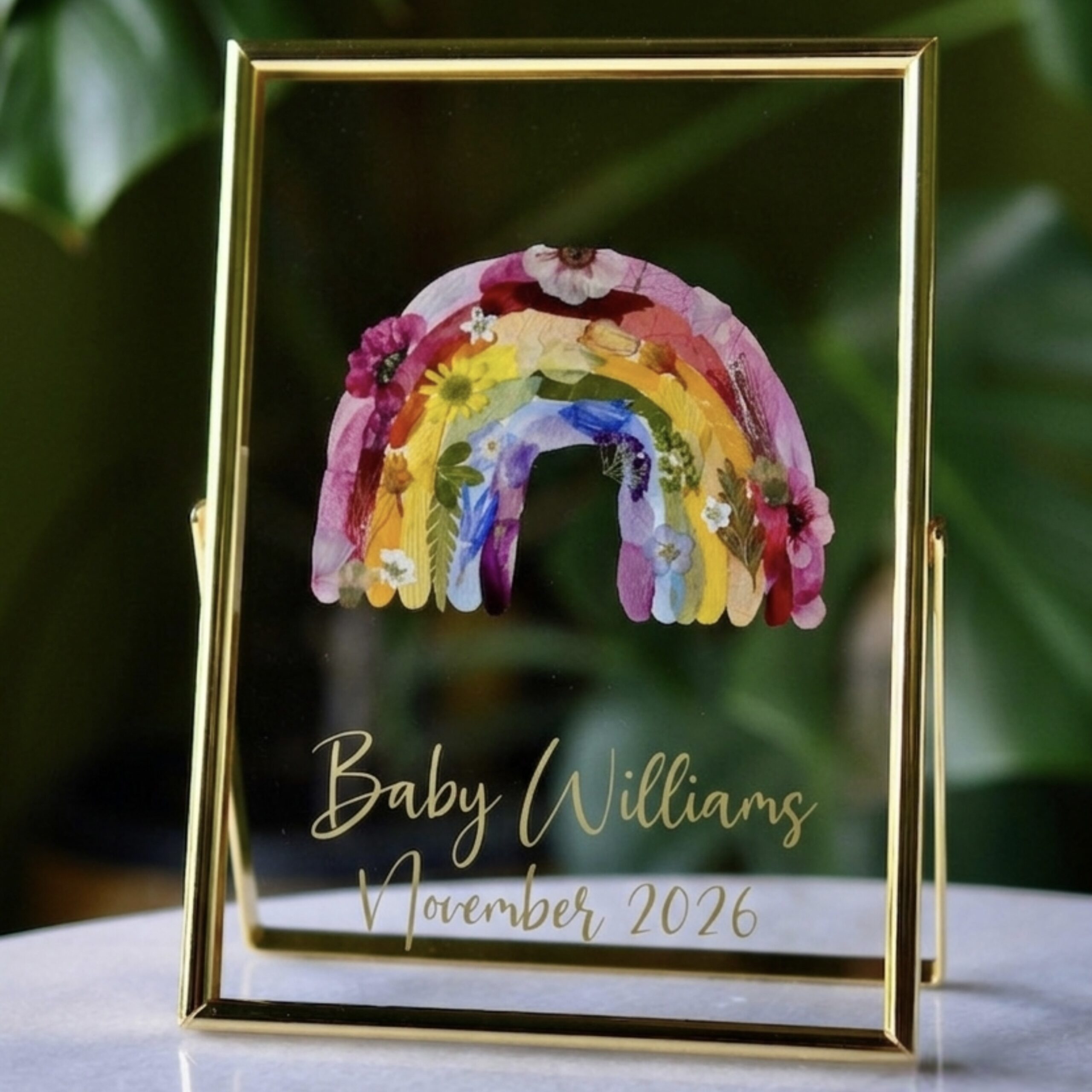 Vibrant Rainbow out of pressed flowers on glass in golden frame with writing